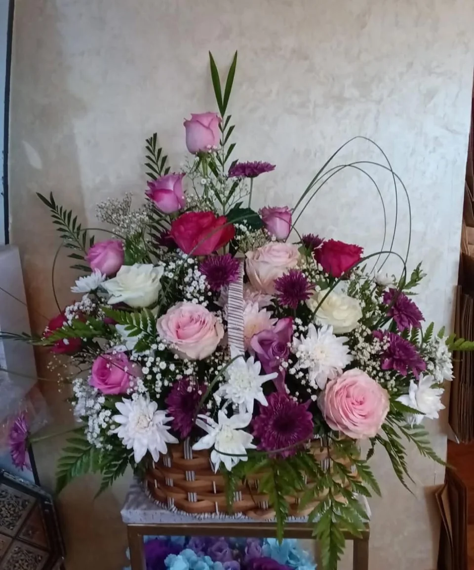 Wellness flower basket with pink, burgundy, purple and white blooms