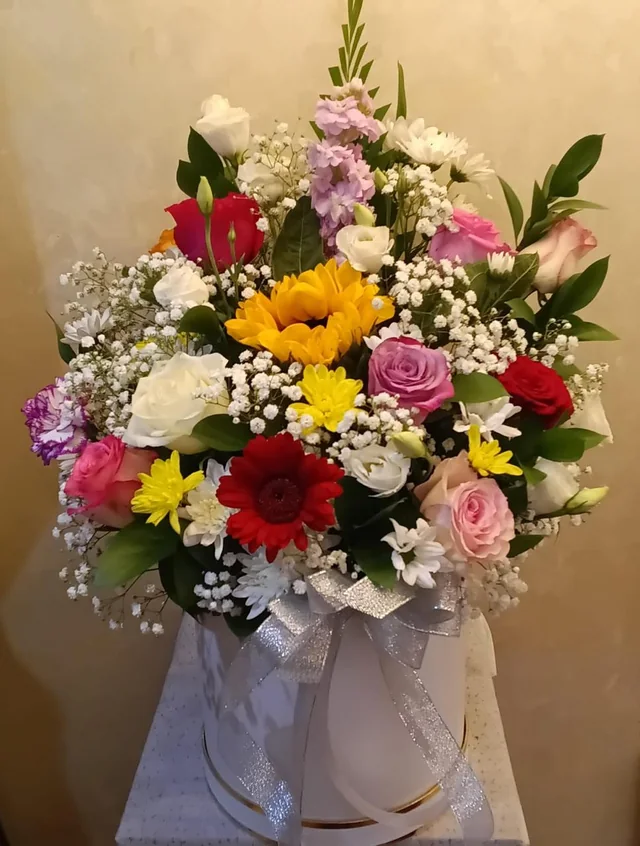 Large celebration flower box with red, pink, yellow and white blooms