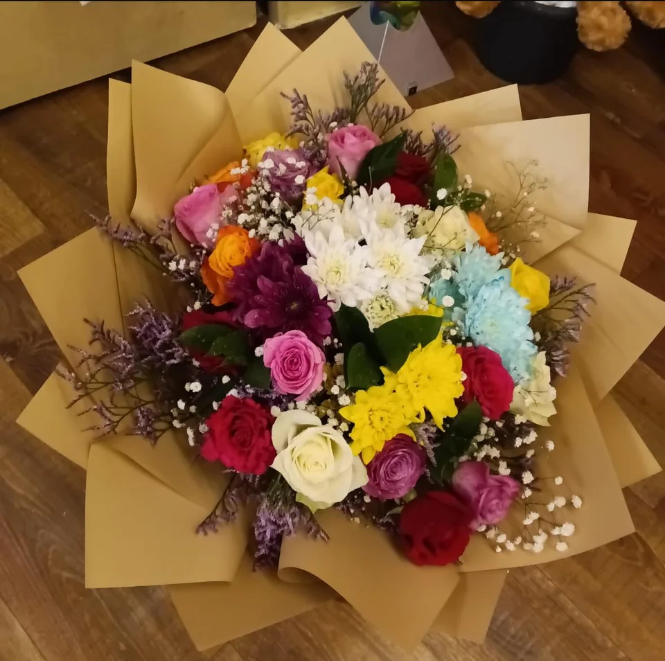 Colourful cheer bouquet with yellow, orange, pink, purple, blue, red and white flowers