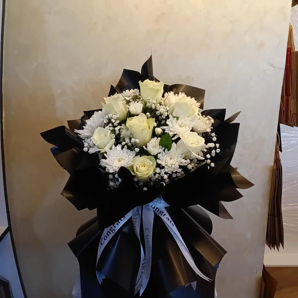 White congratulatory bouquet in black wrapping with printed Congrats ribbons