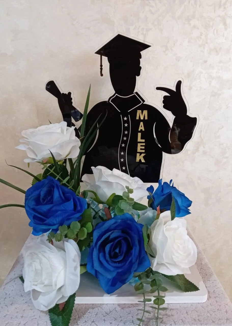 Personalized graduation portrait stand with a graduate silhouette and blue-white flowers