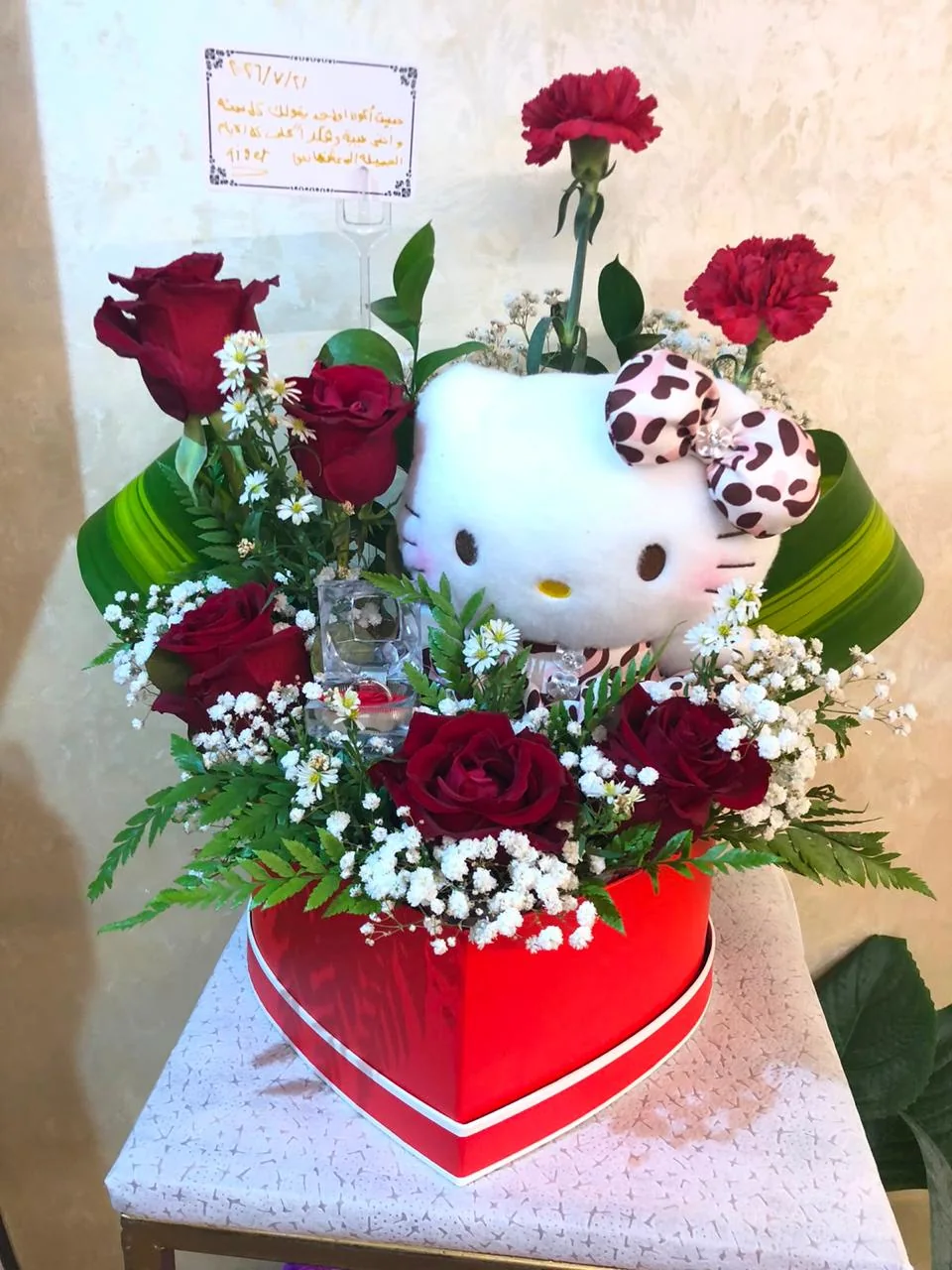 Red heart flower box with roses and a Hello Kitty plush figure