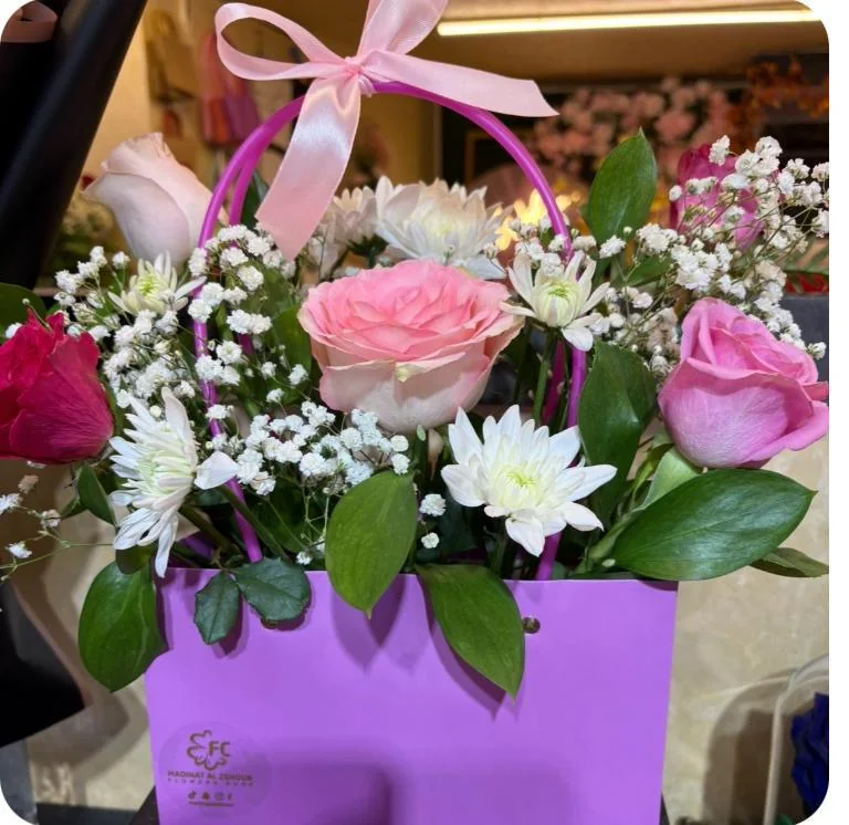Lilac flower bag with pink and purple roses, white daisies and baby's breath