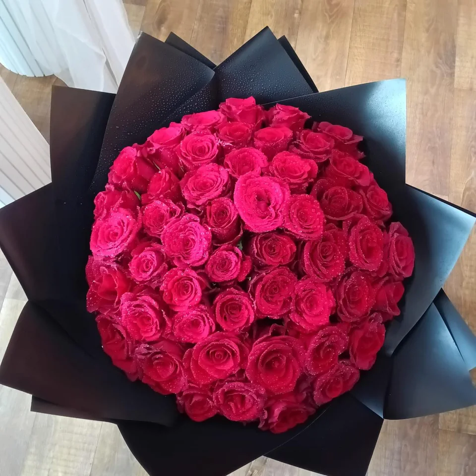 Dense hot-pink rose love bouquet in black wrapping