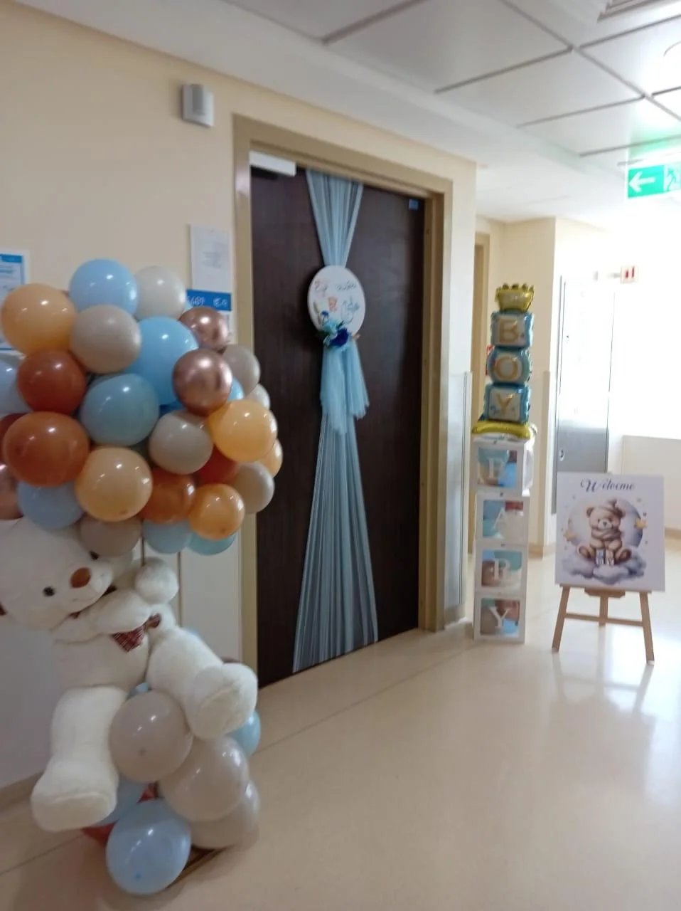 Newborn hospital entrance decoration with teddy balloons, BABY blocks and a welcome sign