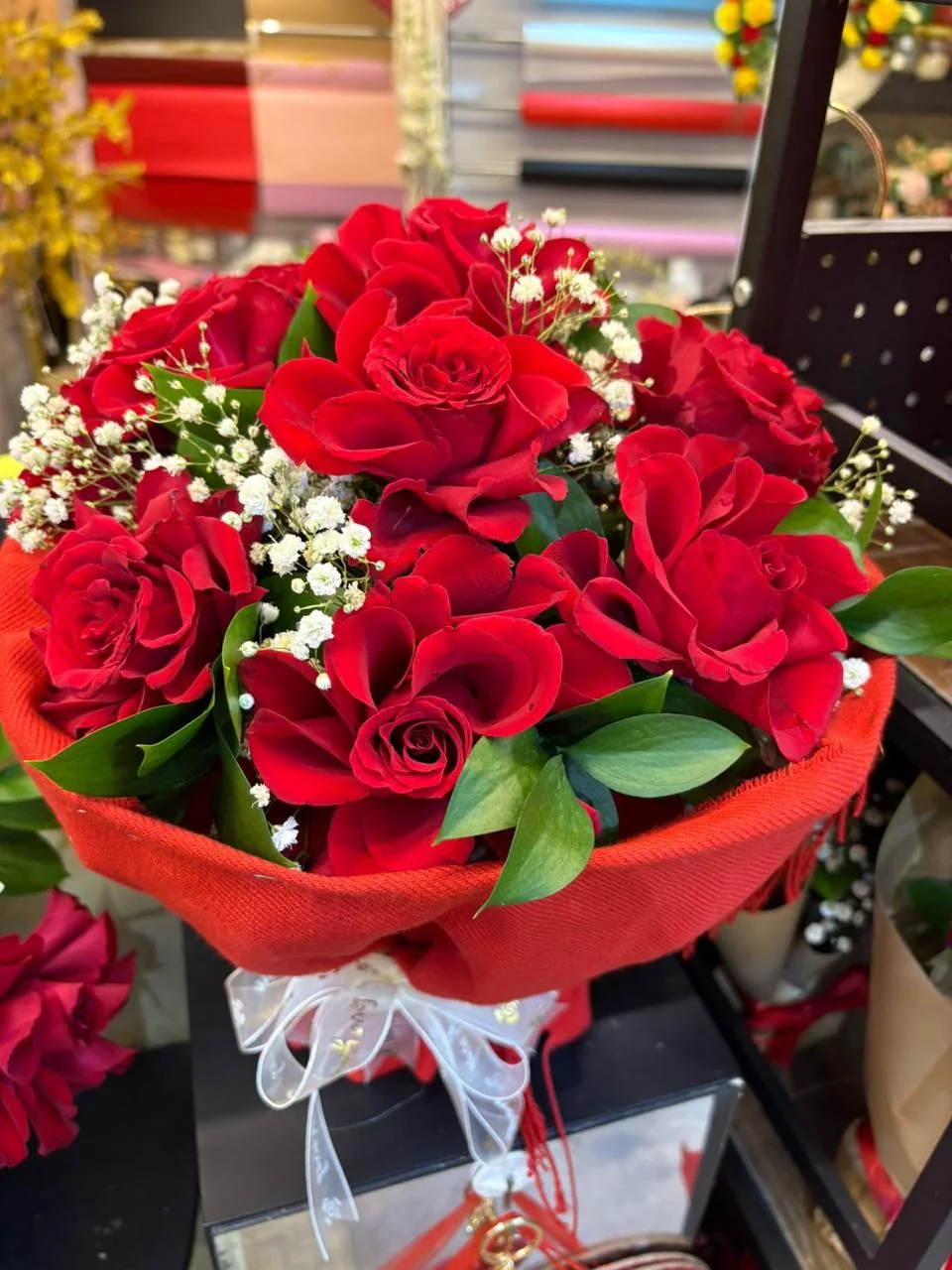 Red scarf bouquet with red roses, red wrapping and white baby's breath