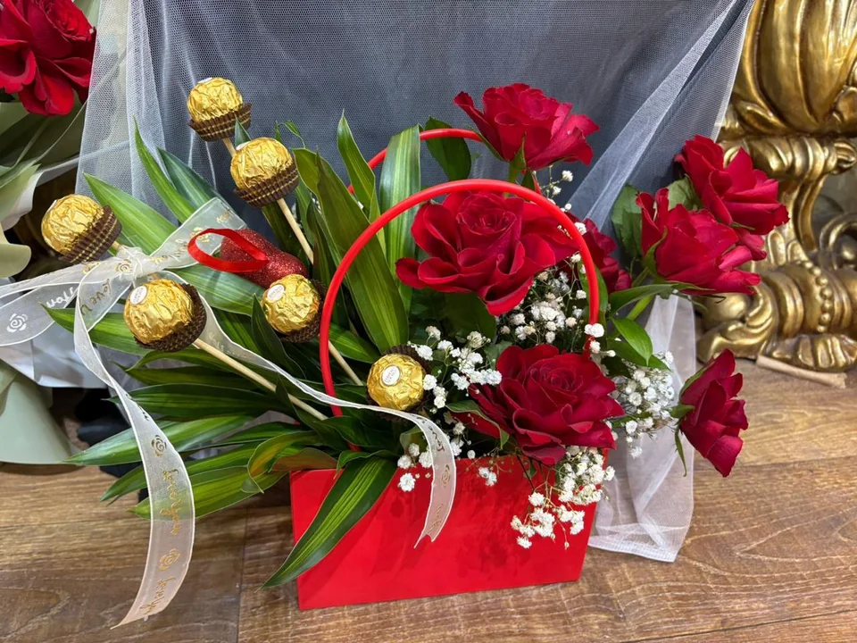 Red romantic flower bag with red roses and wrapped chocolates