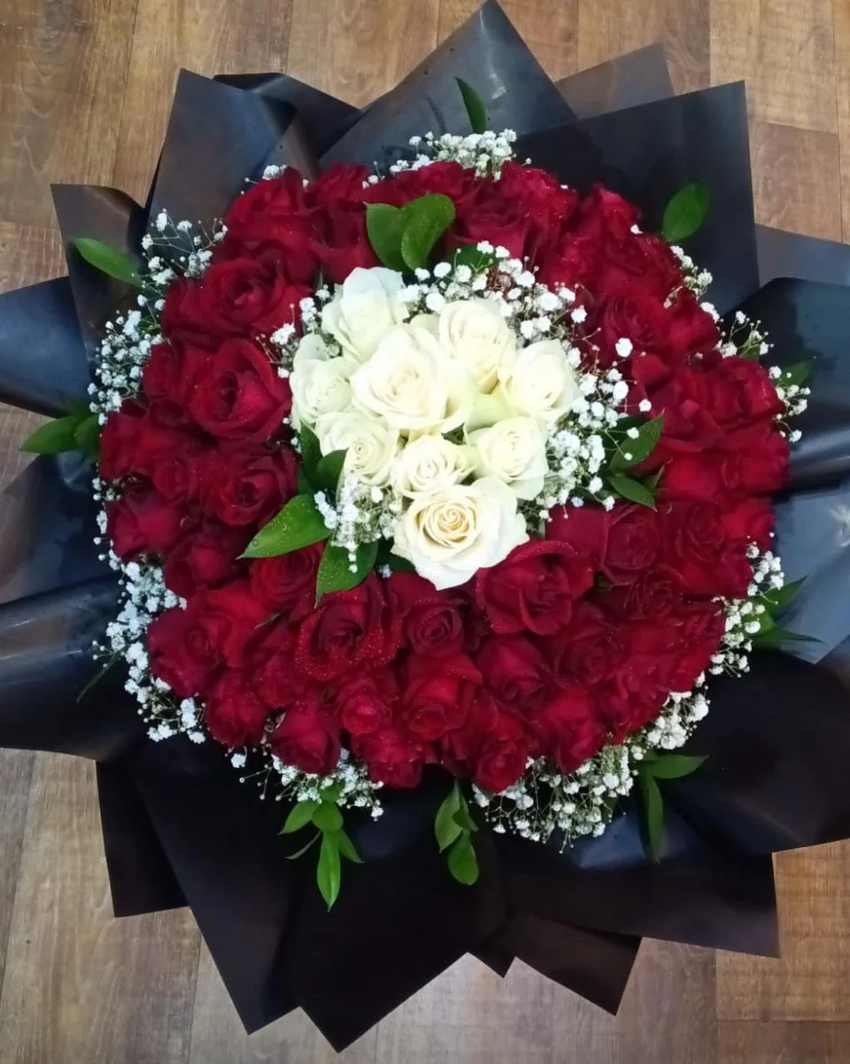 Romantic red rose bouquet with a white heart of roses at the centre