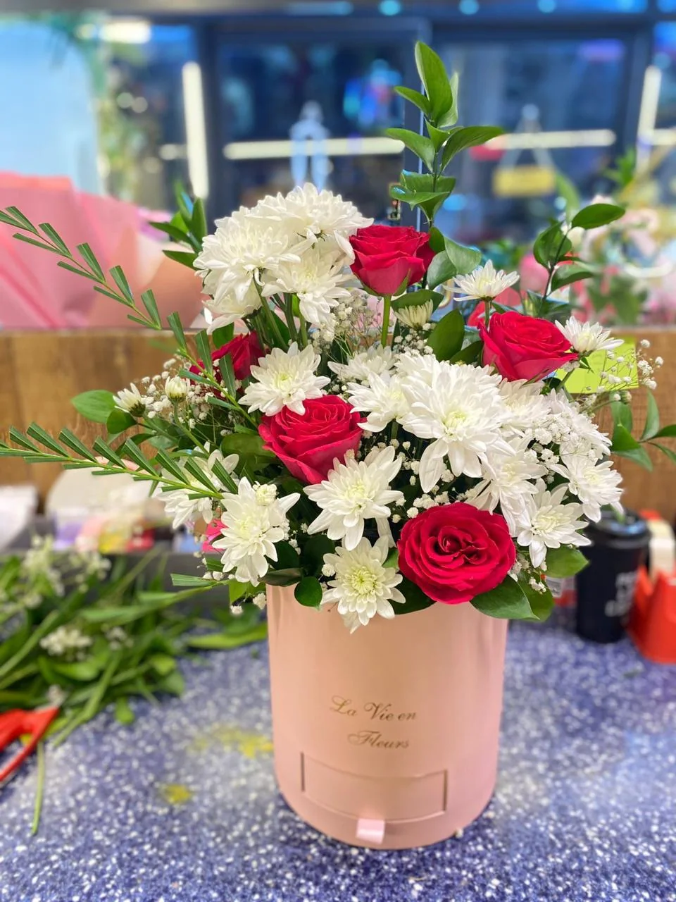 Pink round flower box with red, pink and white blooms