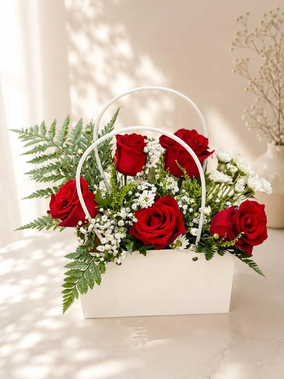 White handled flower bag with red roses and white filler flowers